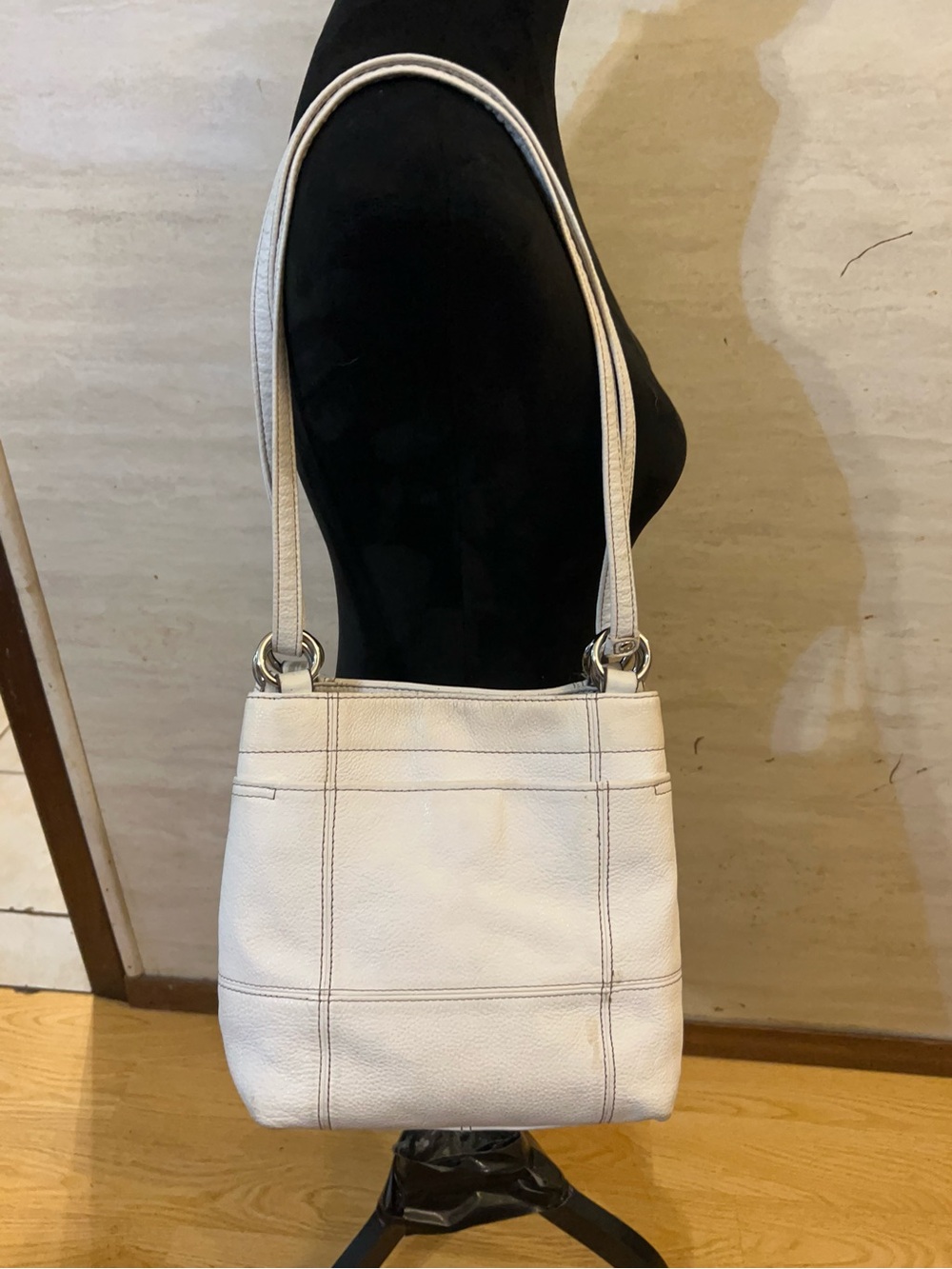 Tignanello white pebbled leather multi-pocket shoulder bag.